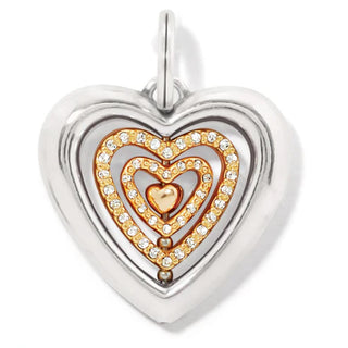 A silver amulet with a heart-shaped design, encrusted with diamonds, on a chain. Brighton