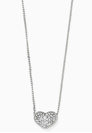 A silver-colored necklace featuring a heart-shaped pendant with a cluster of small diamonds set in the center, attached to an adjustable chain. Brighton