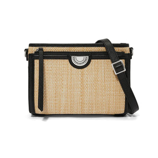 A crossbody organizer handbag featuring a natural straw body with black leather trimmings, equipped with an adjustable black strap and a buckle closure. Brighton