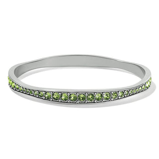 A silver-colored bangle bracelet with green peridot crystals set within a scalloped design on a white background. Brighton