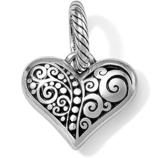 A heart-shaped charm with a silver finish, featuring scroll and dot patterns. Brighton