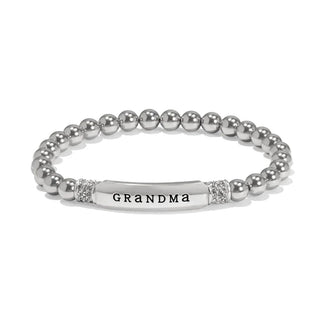 A silver-plated bracelet with a message 'GRANDMA' on a chain, indicating it is a personalized gift for a grandmother. Brighton