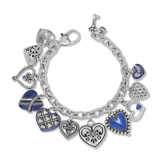 A silver-plated Brighton One Heart Link Charm Bracelet with various heart-shaped charms and blue enamel details.