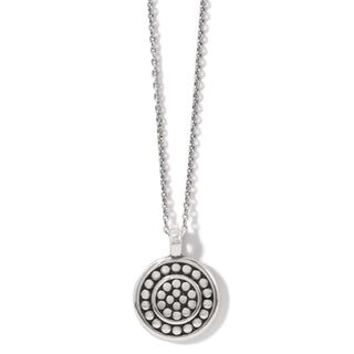 A silver-plated necklace with a round reversible pendant featuring a pebble mosaic design. Brighton