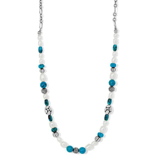 A silver-plated Brighton necklace with turquoise and pearl accents, featuring pebble mosaics as the main design element.