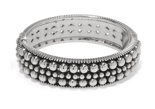 A two-tone (silver and black) bangle bracelet with pierced patterns and beaded details. Brighton