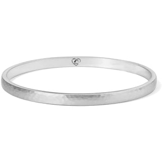 A slender silver bangle bracelet with a hammered texture. Brighton