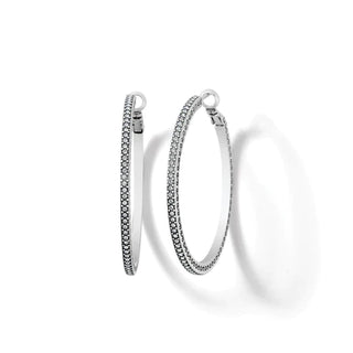 A pair of silver-plated hoop earrings with fine quality crystal pave details, featuring a thin large hoop design. Brighton