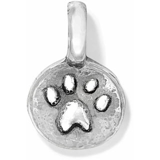 A silver-colored charm in the shape of a paw print with a reflective  Brighton surface.