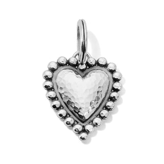 A silver-plated heart-shaped amulet with granulated silver beads around it. Brighton