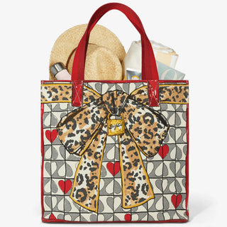 Tote bag with leopard print bow design on a geometric patterned background. Brighton Wild Love Tote