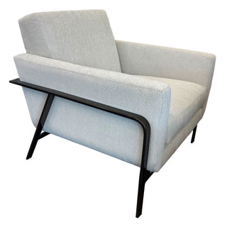 A modern Burton James chair with a Justify Driftwood patterned fabric and a metal frame.