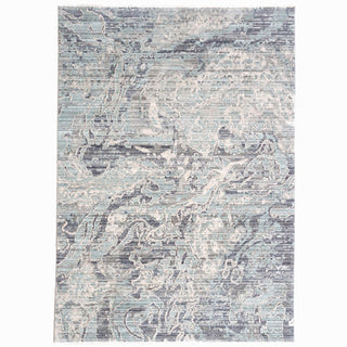 A rectangular area rug with a modern geometric pattern in shades of blue and gray.