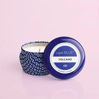 Capri Blue Volcano tin candle in a blue patterned mini tin on a pink background