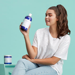 Woman holding Capri Blue Volcano Fabric Softner