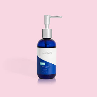 A blue bottle with a silver pump dispenser labeled 'Capri Blue Volcano Hand Wash', containing 7.75 fl oz of hand wash.