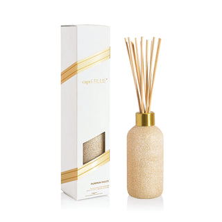 Capri Blue Pumpkin Dulce Diffuser bottle with gold cap and decorative packaging on a white background