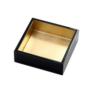 A black rectangular napkin holder with a gold lacquer finish on the inside.