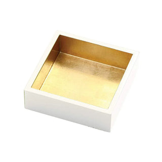An ivory napkin holder with gold lacquer detailing, designed to hold cocktail napkins.
