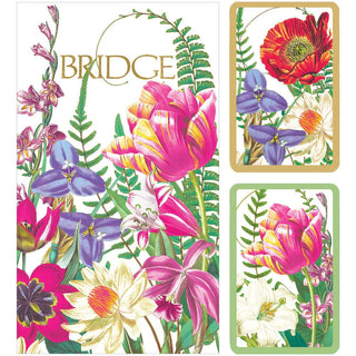 A set of playing cards with a floral design, including close-up images of various colorful flowers and leaves, packaged in a gold gift box.