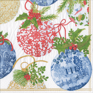 A paper lunch napkin with a Christmas ornament design featuring red and blue patterns with green foliage and decorative elements.