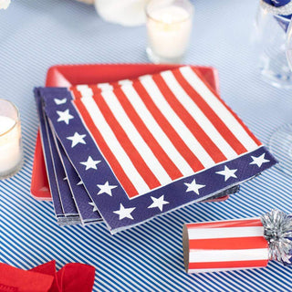 A stack of Caspari Red, White & Blue Cocktail Napkins on a red white and blue tablescape