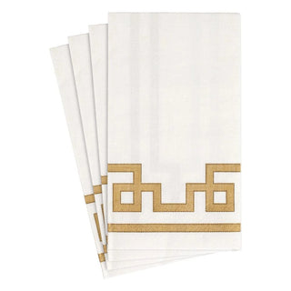 A stack of white paper guest towels with a gold geometric border design.