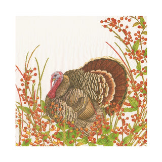 A lunch napkin with a printed design depicting a turkey surrounded by berries.
