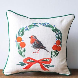 Pillow featuring a Christmas wrath with an orange and gray bird in the center.