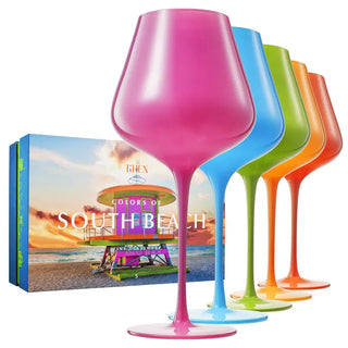 A set of five colorful wine glasses in orange, green, pink, and blue with a large stem design.