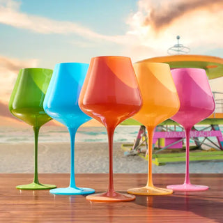A set of five colorful wine glasses in orange, green, pink, and blue with a large stem design.