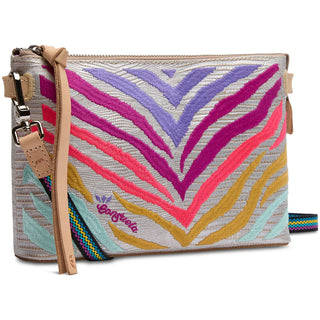 A multicolored Consuela Celeste Midtown Crossbody handbag with a woven strap and leather trim.