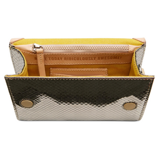 A mirrored crossbody bag with a geometric pattern and a multicolored strap.