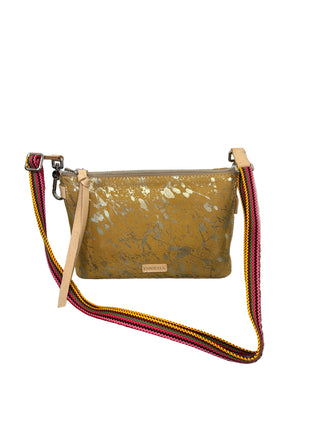 Consuela Marlow Midtown Crossbody
A small crossbody clutch bag with a gold marbled pattern and a colorful woven strap in pink, yellow, and black. 