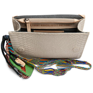 Beige handbag with colorful strap on a white background