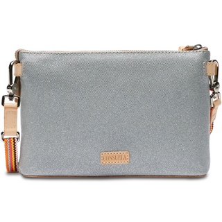 A floral embroidered Consuela Tink Midtown Crossbody handbag with multicolored flowers on a grey background, featuring a natural leather trim and a detachable woven strap.