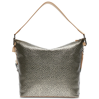A Consuela Hobo bag with a gold and black metallic dotted pattern and a woven multicolored crossbody strap.
