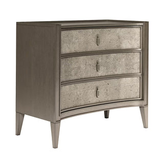 A gray bachelor's chest with three roomy drawers, featuring a concave face design, cork application, metal hardware, and built-in USB chargers on the back. Cove Bachelor Chest