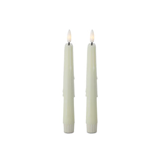 Two lit candles with white wicks on a white background. Cream LED Drip Taper Candles with Timer, Set of 2