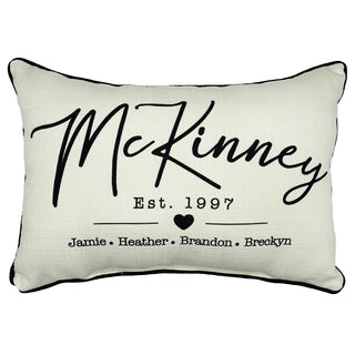 A rectangular personalized pillow with the name 'McKinney' and the text 'Est. 1997' along with the names 'Jamie, Heather, Brandon, Breckyn'.