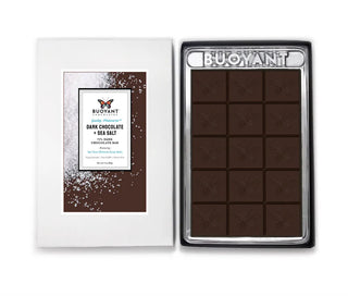 Dark chocolate bar with sea salt in a white box, featuring the Buoyant brand