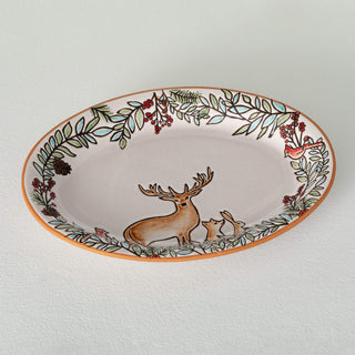 Decorative plate with a deer design on a white background