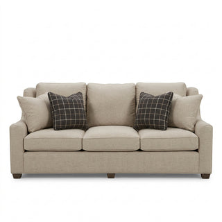 Drake Sofa in Botany Hemp
A light beige fabric sofa with two dark gray plaid accent pillows. 