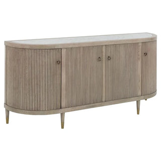 A wooden credenza with a white marble top, featuring four doors with brass hardware, set on short legs.