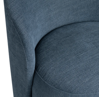 Close-up of a textured blue chair with a white background