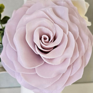A close-up image of a pink rose-shaped petal soap flower. Fields of Provence Petal Soap Flower.