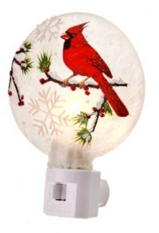 Glass Cardinal Night Light Assorted
A festive Christmas night light featuring a round frosted glass globe with a red cardinal perched on a snowy branch decorated with snowflakes and red berries, mounted on a white plastic plug-in base.