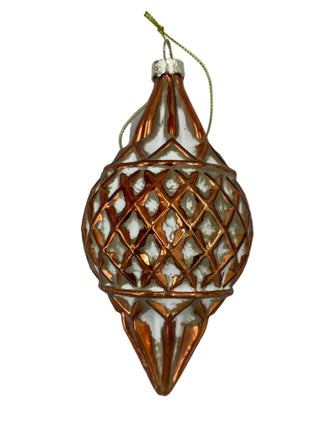 Glass Weave Ball / Finial Ornament Assorted
A bronze copper colored metal Christmas ornament with a lattice pattern and a hanging string, shown on a light gray textured background. white cream finial