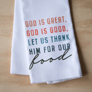 White towel with colorful text on a wooden surface