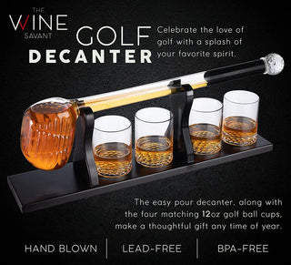 A whiskey decanter set featuring a golf club-shaped decanter and four whiskey glasses arranged on a mahogany wood base.